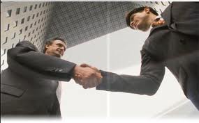 people shaking hands in front of a bank, young teller applicant, and an older hiring manager