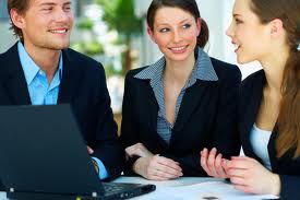 young job applicants work together on a task in a group interview at a bank